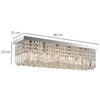 Vela chandelier hanging above a stylish living space, demonstrating its statement presence and modern aesthetic