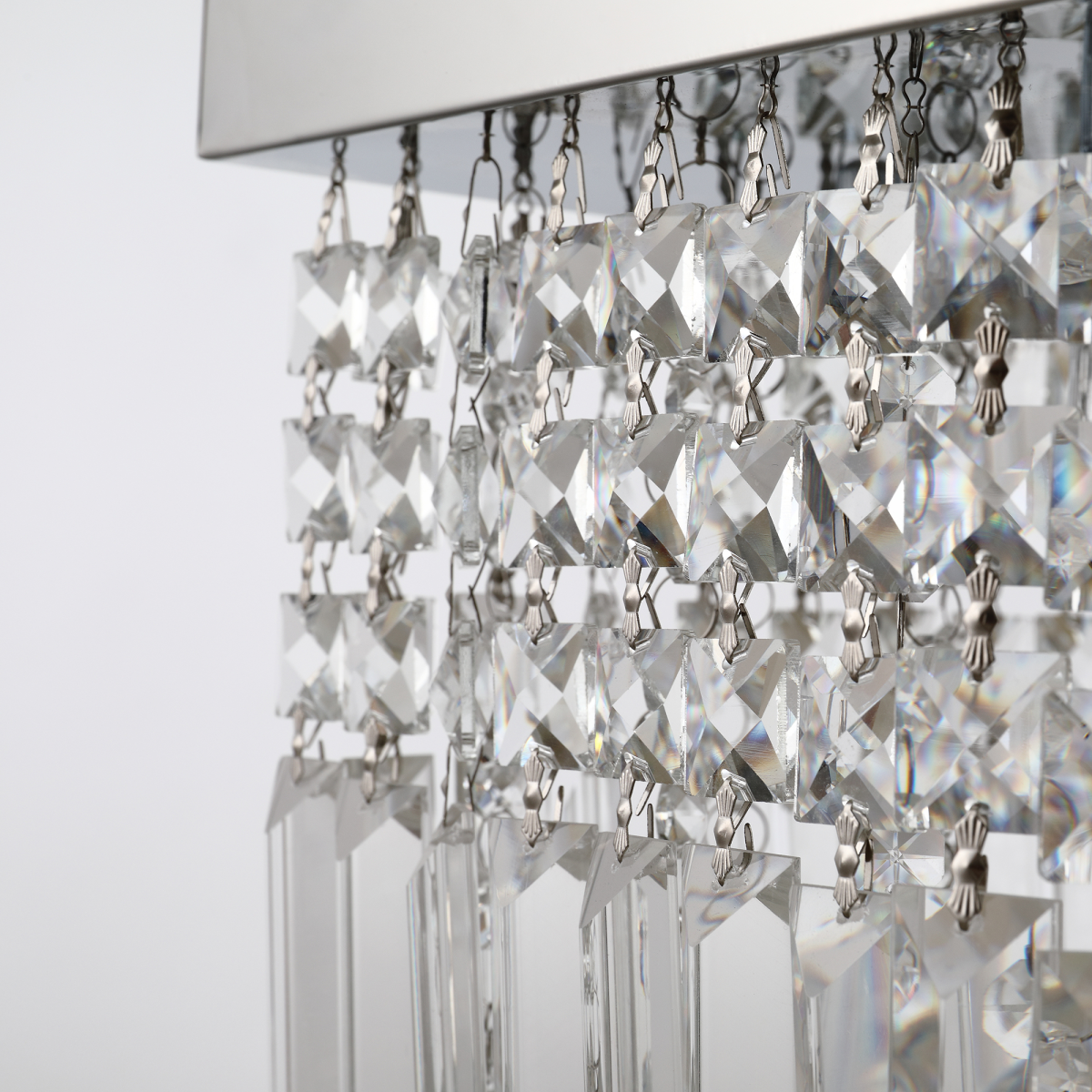 Vela modern chandelier with rectangular crystals, installed in a sophisticated hallway with ambient lighting
