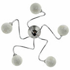 Lifestyle shot of the Solace ceiling light illuminating a contemporary dining area, emphasising its stylish presence