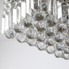 Vela chandelier in a luxurious setting, highlighting its contemporary design and sparkling crystal details