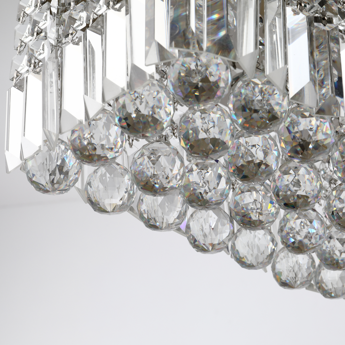 Vela chandelier in a luxurious setting, highlighting its contemporary design and sparkling crystal details