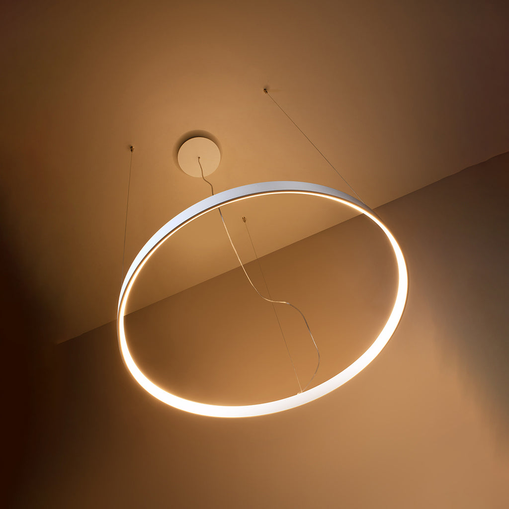 Aurelia pendant chandelier hanging above a dining table, creating a sophisticated atmosphere