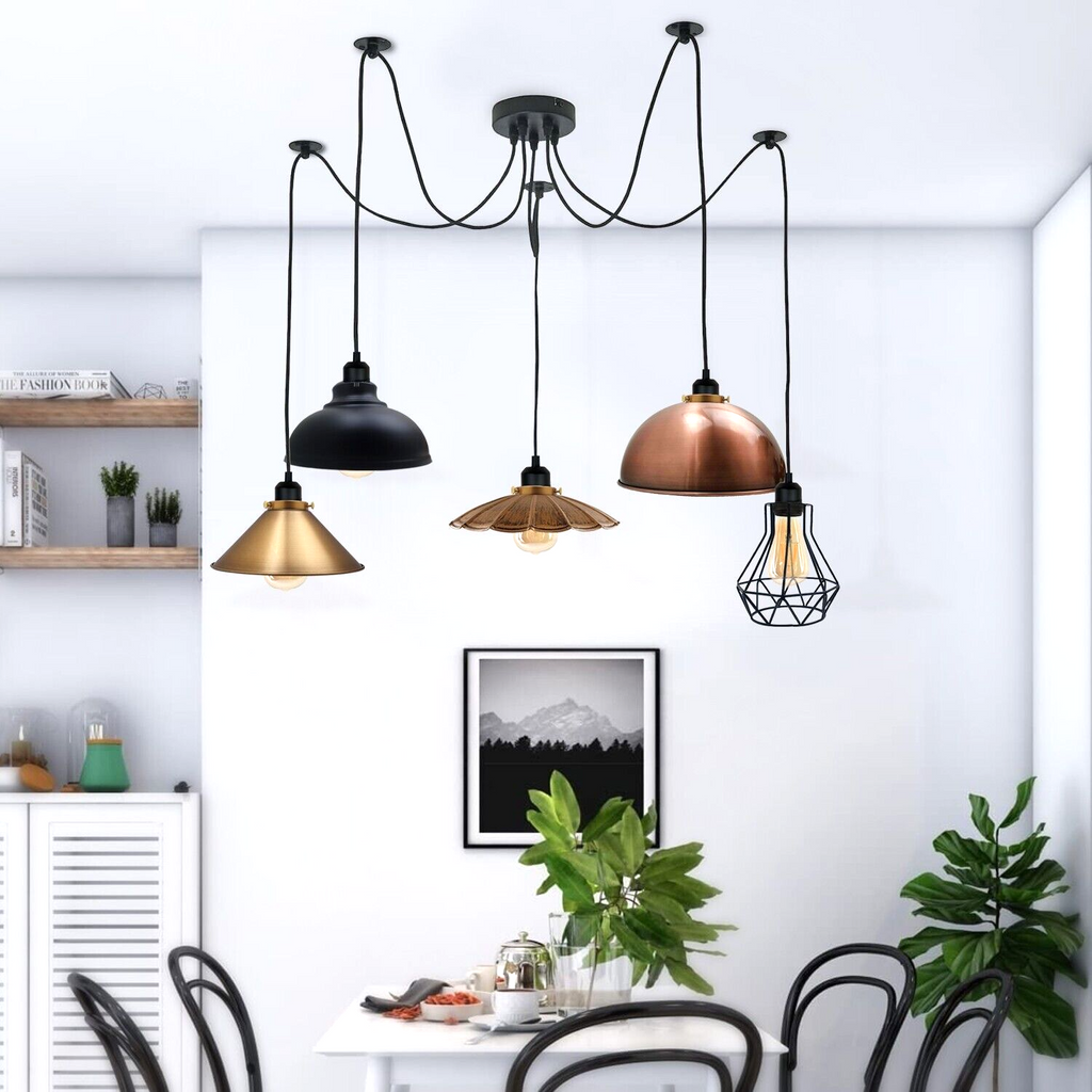 Borough industrial spider pendant with mixed vintage shades above a kitchen dining table