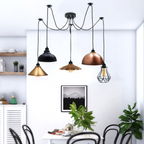 Borough industrial spider pendant with mixed vintage shades above a kitchen dining table
