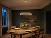 Aurelia LED halo pendant above oak dining table in studio-green panelled Georgian dining room