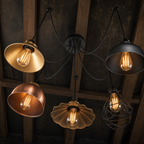 Borough spider pendant chandelier close-up detail showing all five mixed vintage shades and black ceiling canopy from below
