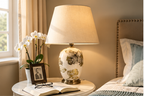 Elowen botanical ceramic table lamp styled on a bedside table in a warm bedroom