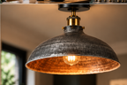 Close-up lifestyle view of the Emberholt brushed silver ceiling light with warm copper-toned interior