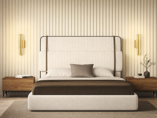 Pair of Hatton brushed-gold geometric mesh wall sconces flanking a cream boucle upholstered headboard in a boutique hotel bedroom