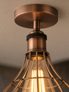 Close-up detail of the Bethnal Green copper wireframe cage and knurled bronze bulb holder
