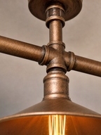 Close-up detail of the Limehouse ceiling light showing brushed copper pipe joints and patina