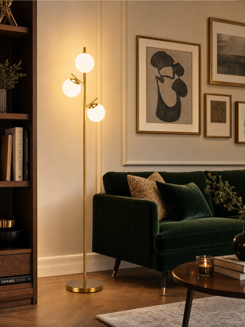 Kensington Gold Tone 3-Light Globe Tree Floor Lamp in elegant living room with green velvet sofa