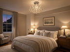 Lyra petite round crystal chandelier in a soft greige townhouse principal bedroom at dusk