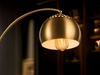 Close-up of the Mayfair brushed gold perforated dome shade with Edison filament bulb