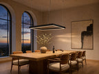 Meridian rectangular halo LED pendant chandelier above a long oak dining table at twilight