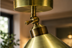 Close-up of the Netherfield green brass ceiling light adjustable swivel joint and brushed metal finish