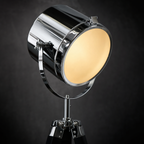 Close-up detail of the Pinewood floor lamp polished chrome searchlight head showing gimbal yoke mount and warm interior glow