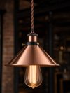 Close-up detail of the Wapping pendant light showing polished copper cone shade and twisted fabric cable